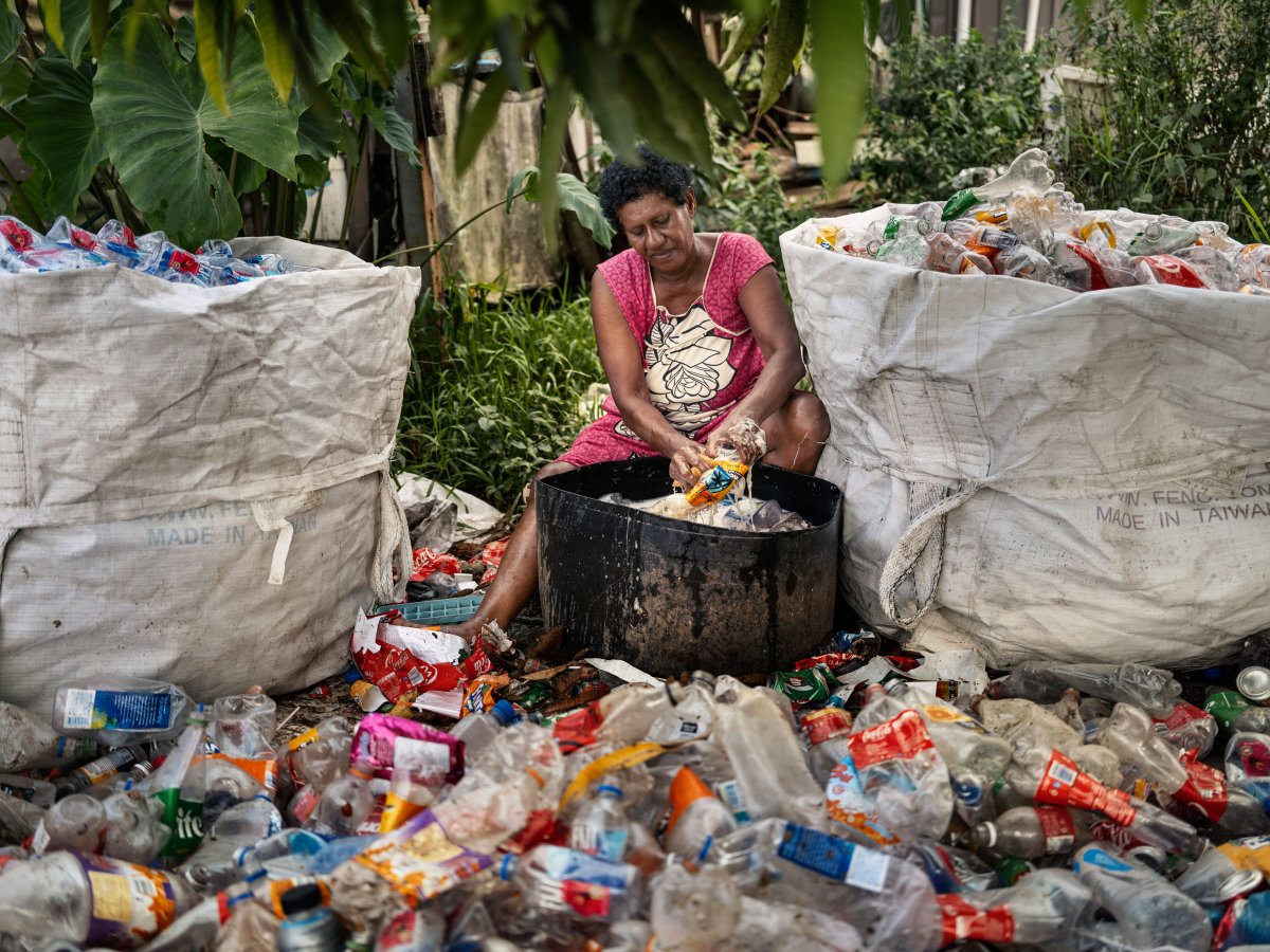 Lisi Namole washes and sorts plastic bottles for recycling in Vunato settlement, Lautoka, Viti Levu, Fiji on May 6, 2024. Lisi makes an income from scavenging, washing and sorting cans and plastic bottles for recycling. Photo by Adam Ferguson for TIME
