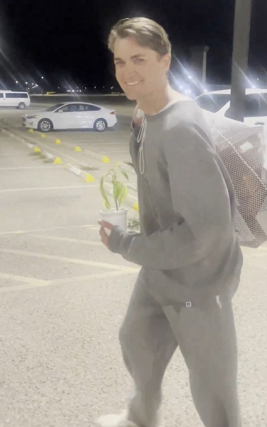 Photo of Ross Ulbricht walking out of prison while holding a plant